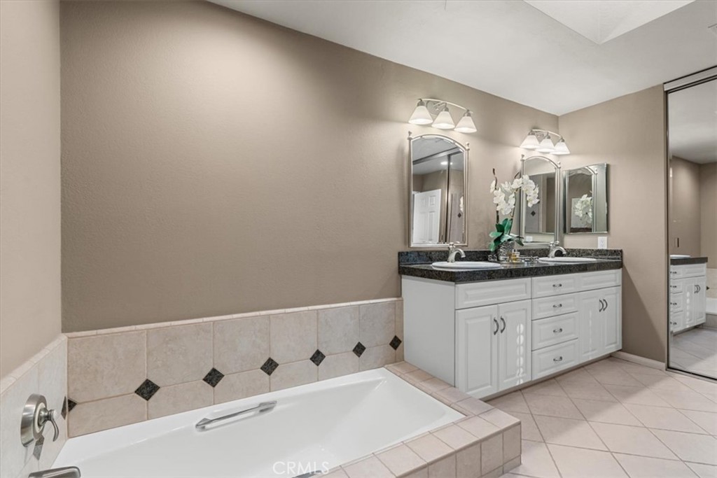 393 Gran Via Palm Desert, CA 92260 - Photo 23 of 60 a bathroom with a double vanity sink and a mirror