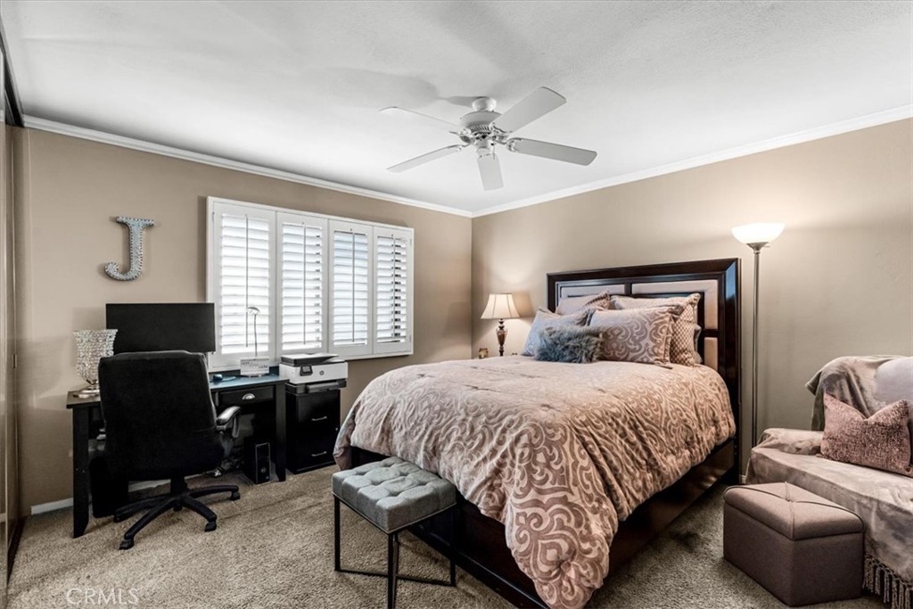 393 Gran Via Palm Desert, CA 92260 - Photo 24 of 60 a bedroom with a bed and a chandelier