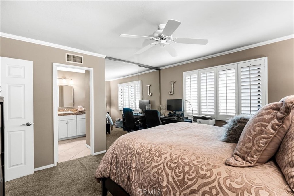 393 Gran Via Palm Desert, CA 92260 - Photo 25 of 60 a bed room with a bed and a large mirror