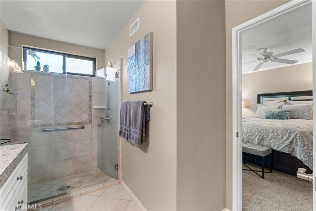 393 Gran Via Palm Desert, CA 92260 - Photo 27 of 60 a view of a bedroom with a bed and a window