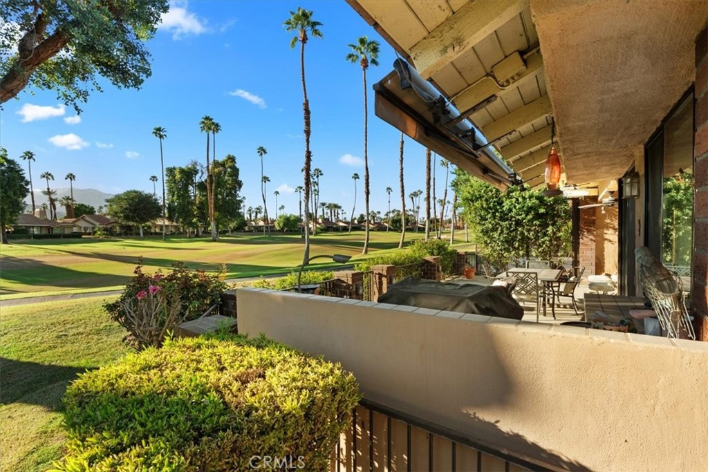 393 Gran Via Palm Desert, CA 92260 - Photo 30 of 60 a view of a swimming pool with a yard and sitting area