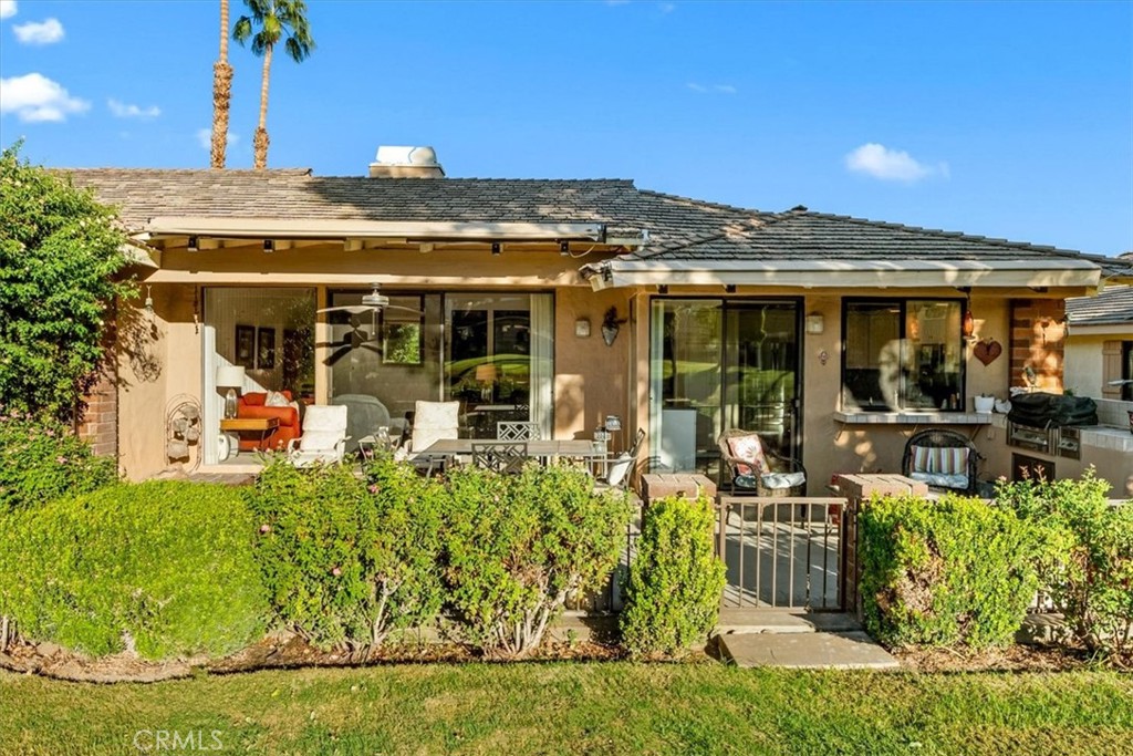 393 Gran Via Palm Desert, CA 92260 - Photo 31 of 60 a view of a chairs and table in a patio