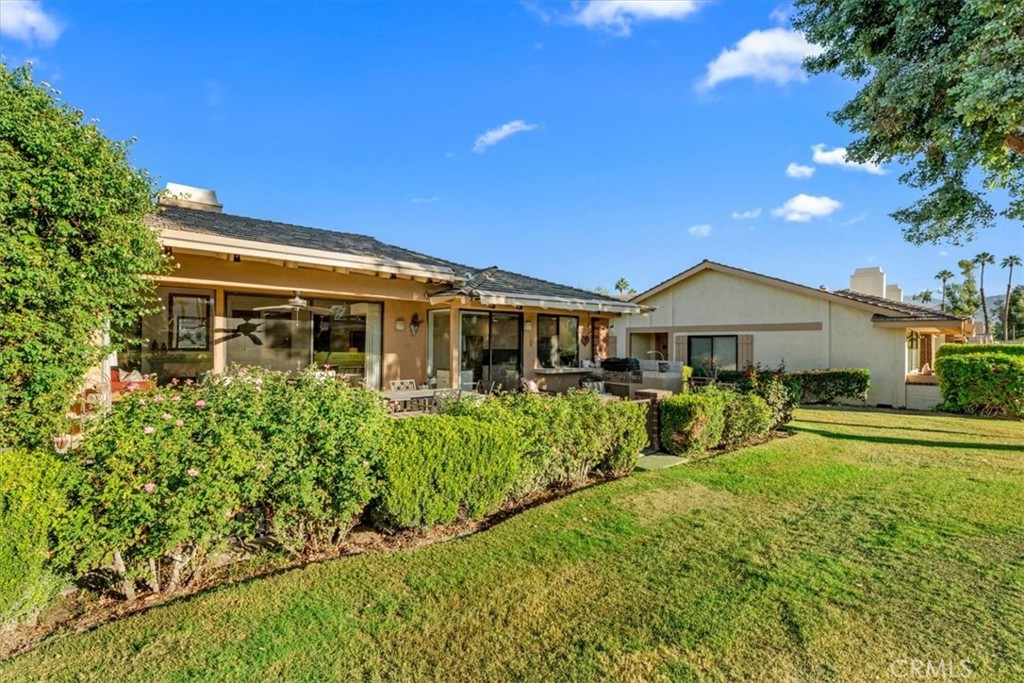 393 Gran Via Palm Desert, CA 92260 - Photo 34 of 60 a front view of a house with garden