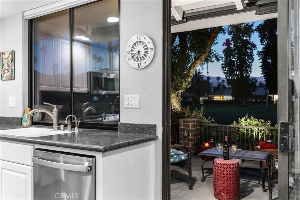393 Gran Via Palm Desert, CA 92260 - Photo 38 of 60 a kitchen with a sink and cabinets