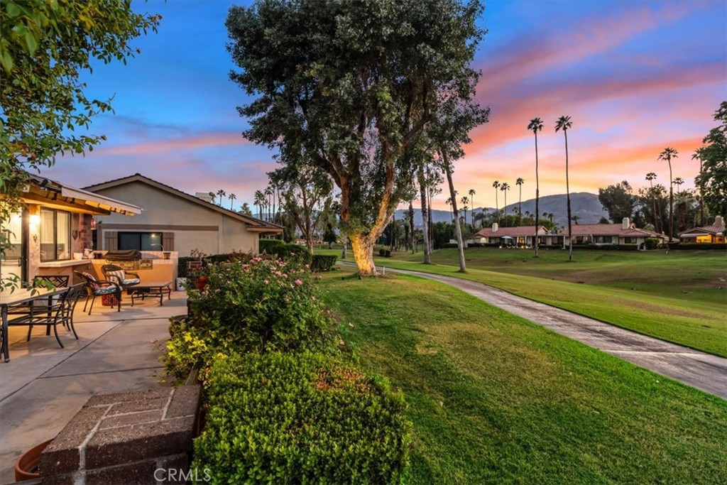393 Gran Via Palm Desert, CA 92260 - Photo 44 of 60 a view of a house with a big yard and potted plants