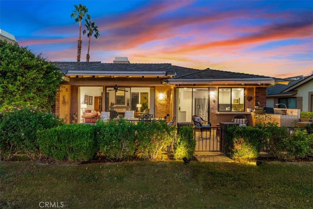 393 Gran Via Palm Desert, CA 92260 - Photo 48 of 60 a front view of a house with a yard