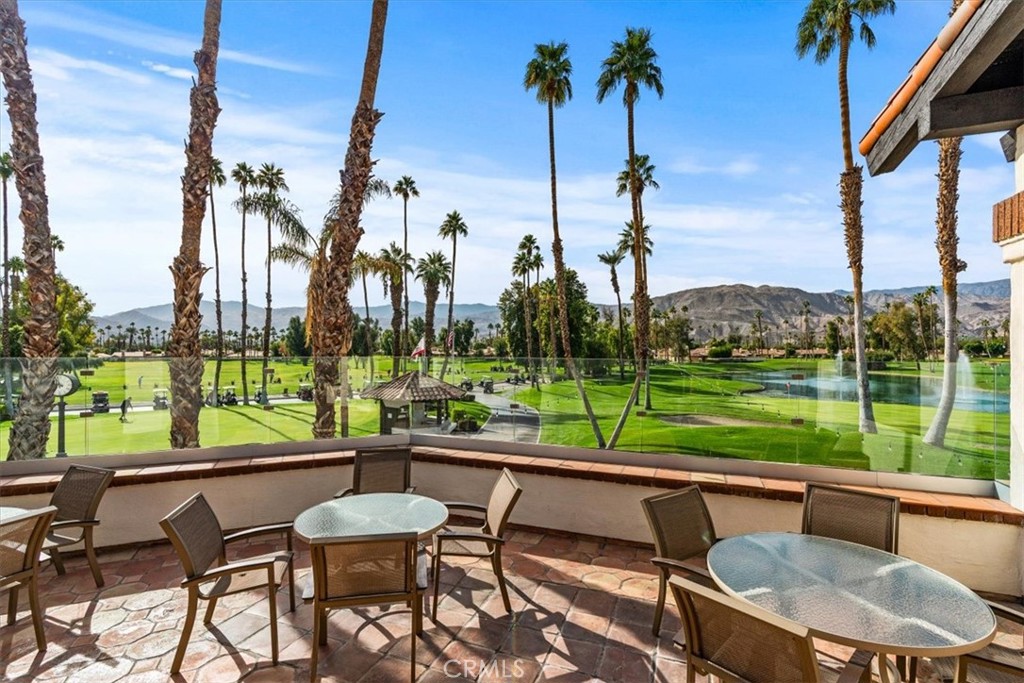 393 Gran Via Palm Desert, CA 92260 - Photo 54 of 60 a view of a patio with a table chairs and a table