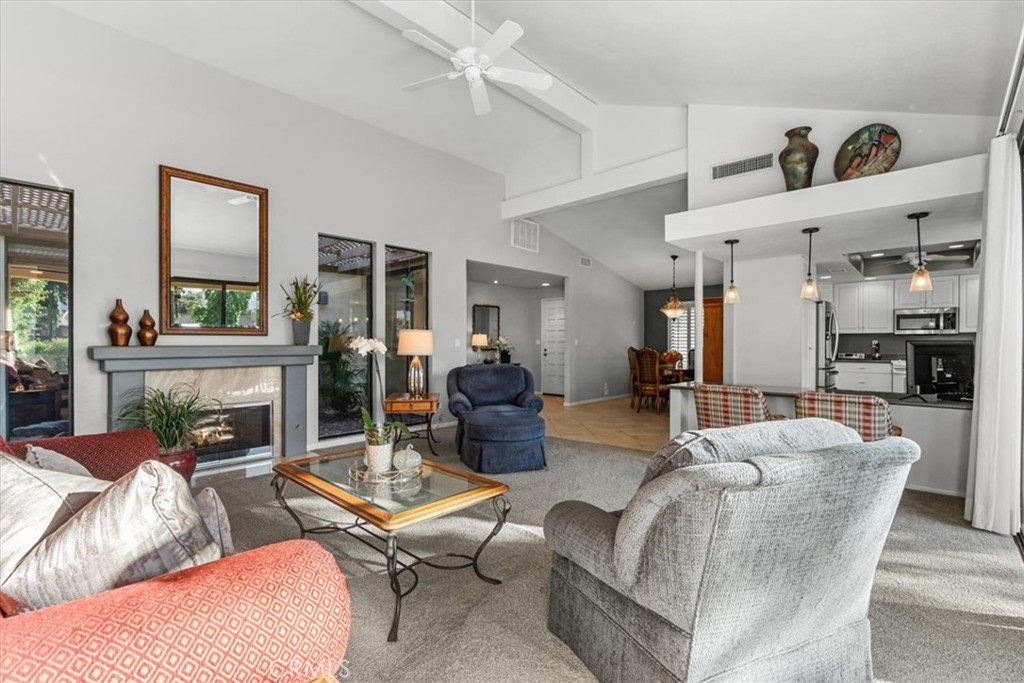393 Gran Via Palm Desert, CA 92260 - Photo 7 of 60 a living room with furniture kitchen view and a large window