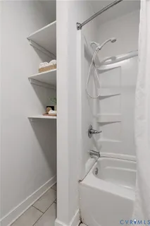 a bathroom with a bathtub and a shower