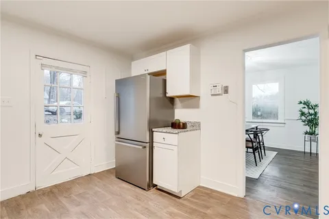 a kitchen with stainless steel appliances a refrigerator and a stove top oven