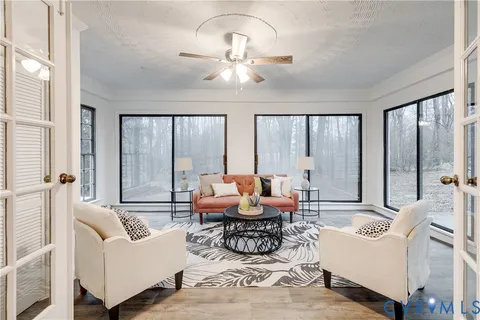 a living room with furniture and large windows