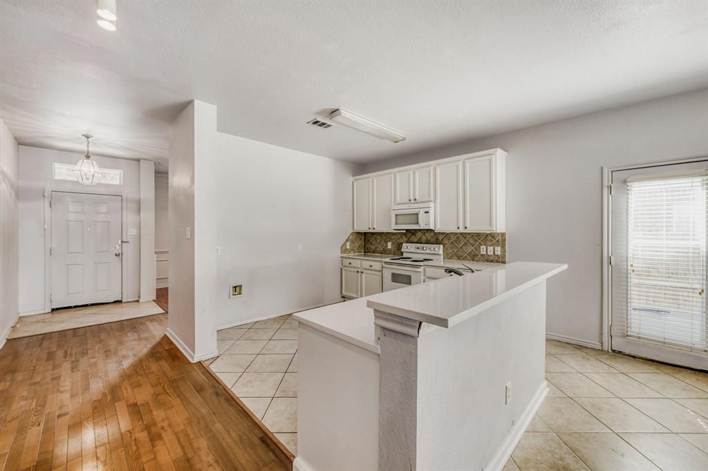 2617 Hereford Road Denton, TX 76210 - Photo 11 of 27 a kitchen with cabinets and white appliances