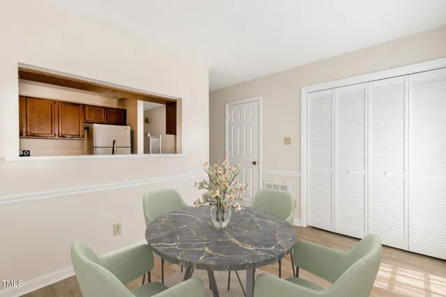 a view of a room with wooden floor and white walls