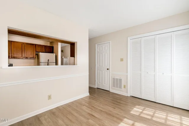 a dining room with furniture and wooden floor