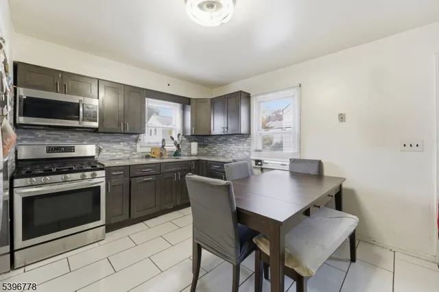 a kitchen with a stove a sink and a microwave