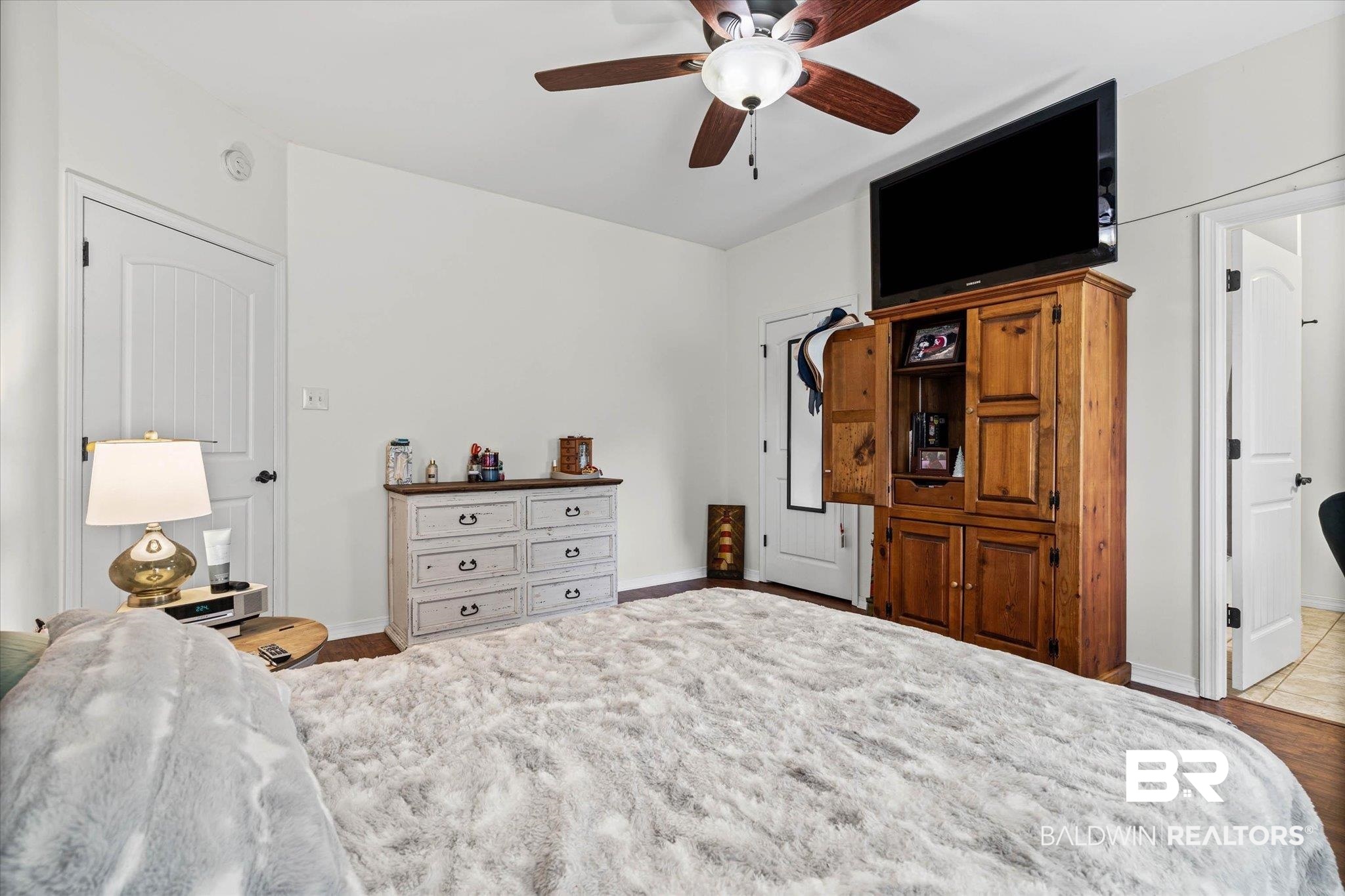 800 Galoway Avenue Mobile, AL 36609 - Photo 12 of 22 Spacious room featuring wood-finish flooring, white walls, and a ceiling fan with integrated lighting