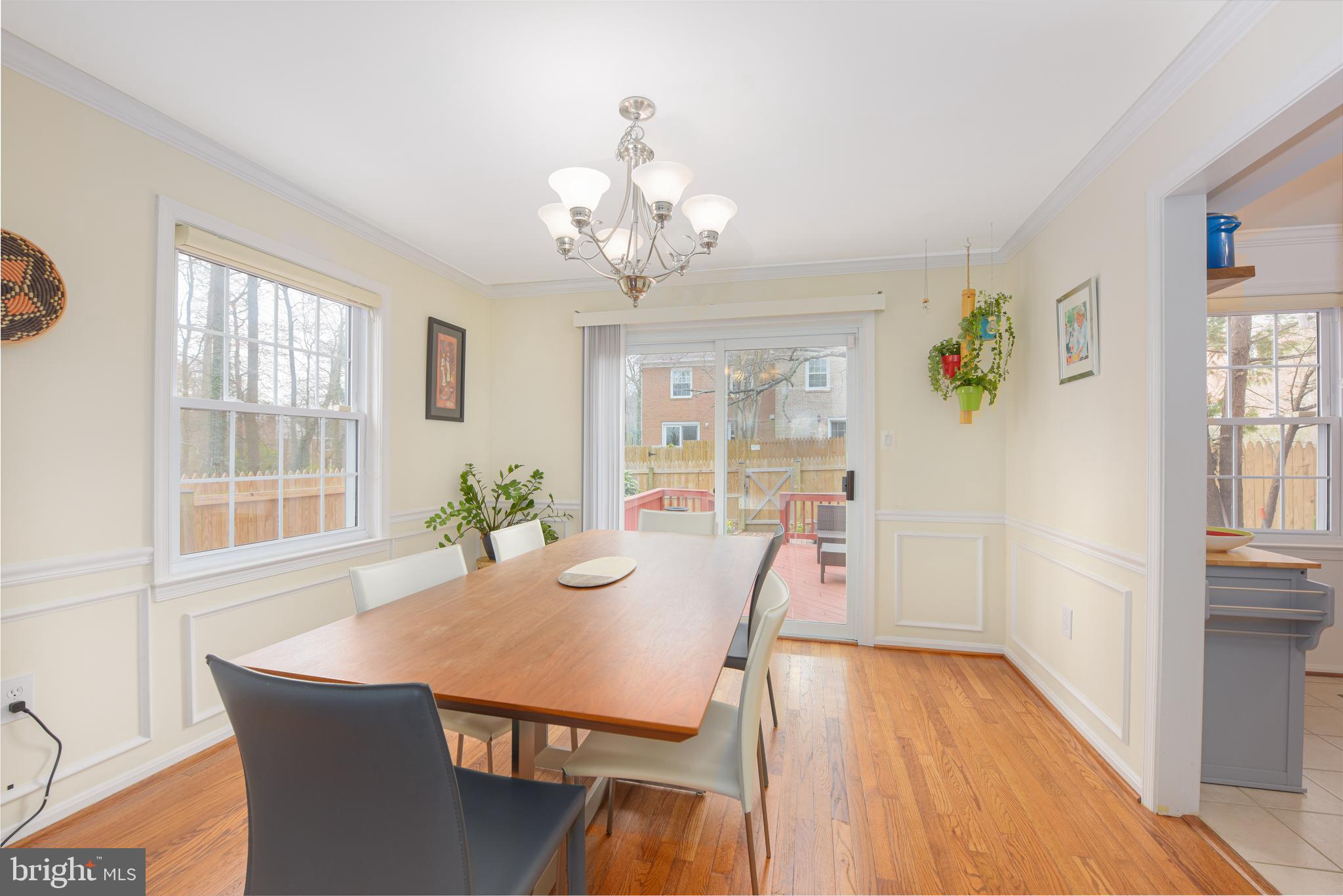 7031 Leestone Street Springfield, VA 22151 - Photo 16 of 42 a view of a dining room with furniture a chandelier and wooden floor