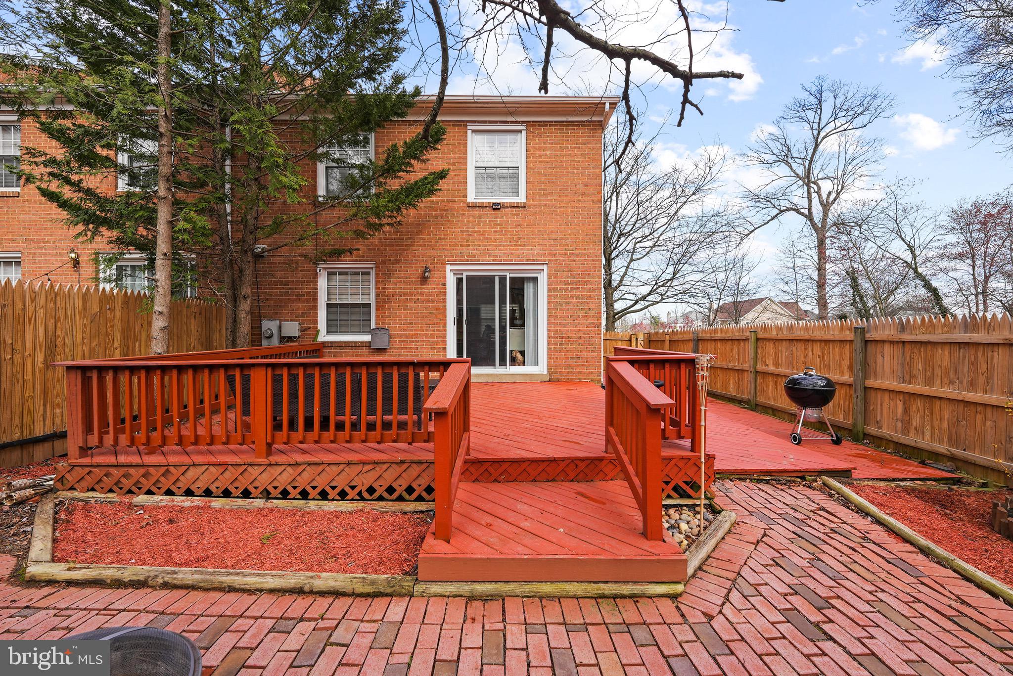 7031 Leestone Street Springfield, VA 22151 - Photo 28 of 42 a view of a wooden deck with a yard