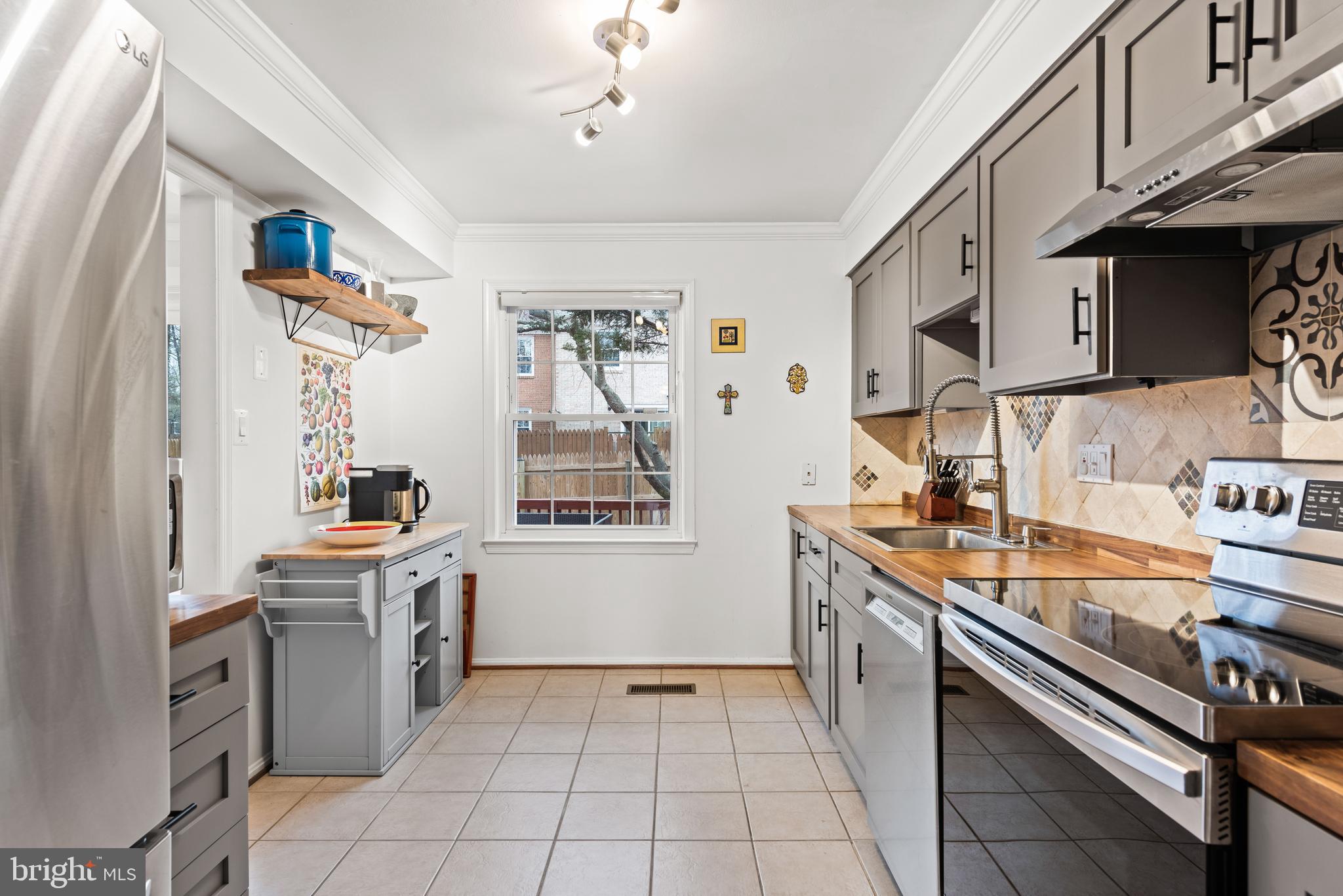 7031 Leestone Street Springfield, VA 22151 - Photo 5 of 42 a kitchen with a sink cabinets and window