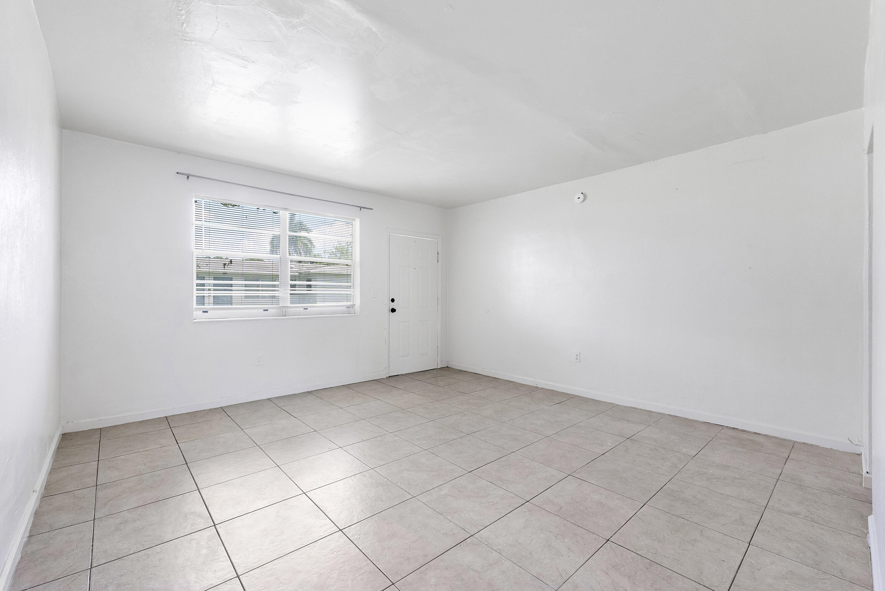 515 Northeast 150th Street, Unit 3 Miami, FL 33161 - Photo 1 of 11 an empty room with windows