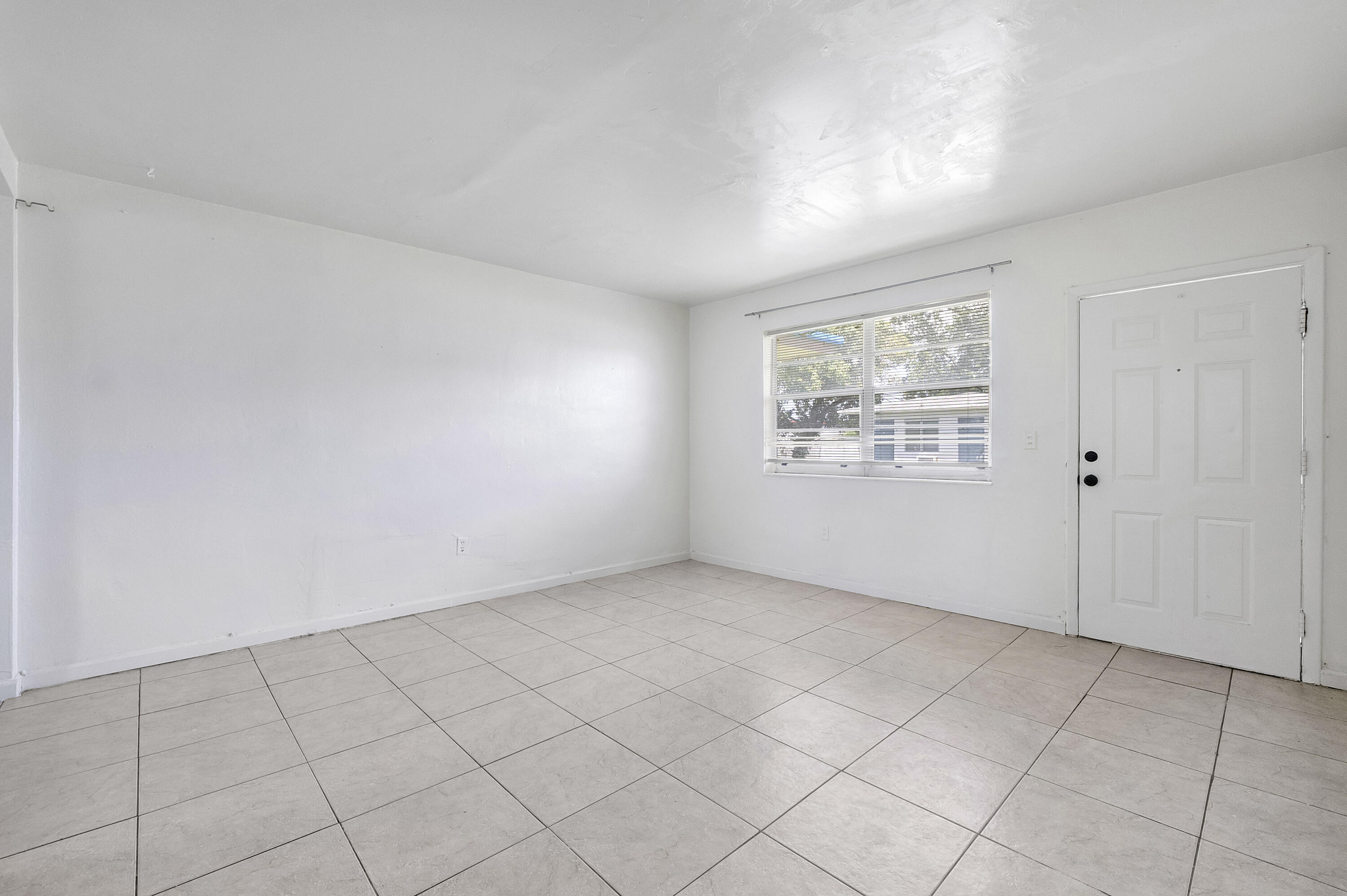 515 Northeast 150th Street, Unit 3 Miami, FL 33161 - Photo 2 of 11 an empty room with windows