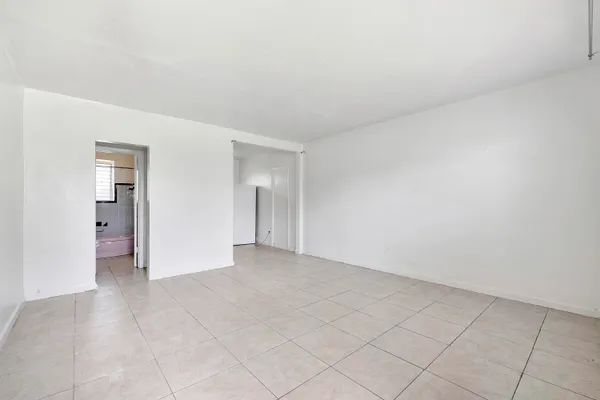 a view of an empty room and closet area