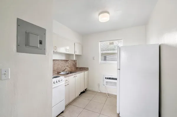 a kitchen with a sink and a stove top oven