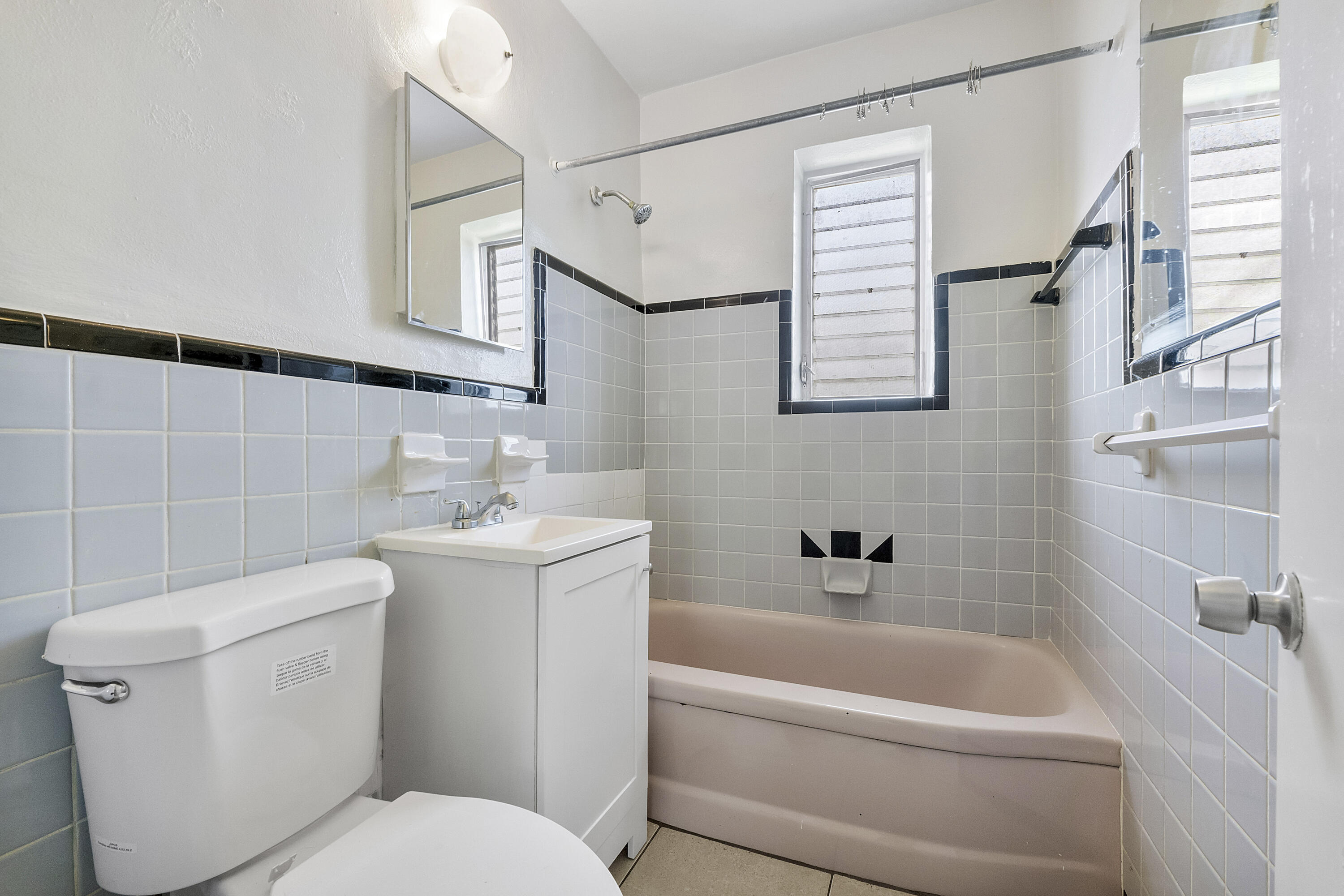 515 Northeast 150th Street, Unit 3 Miami, FL 33161 - Photo 7 of 11 a bathroom with a toilet sink and bathtub