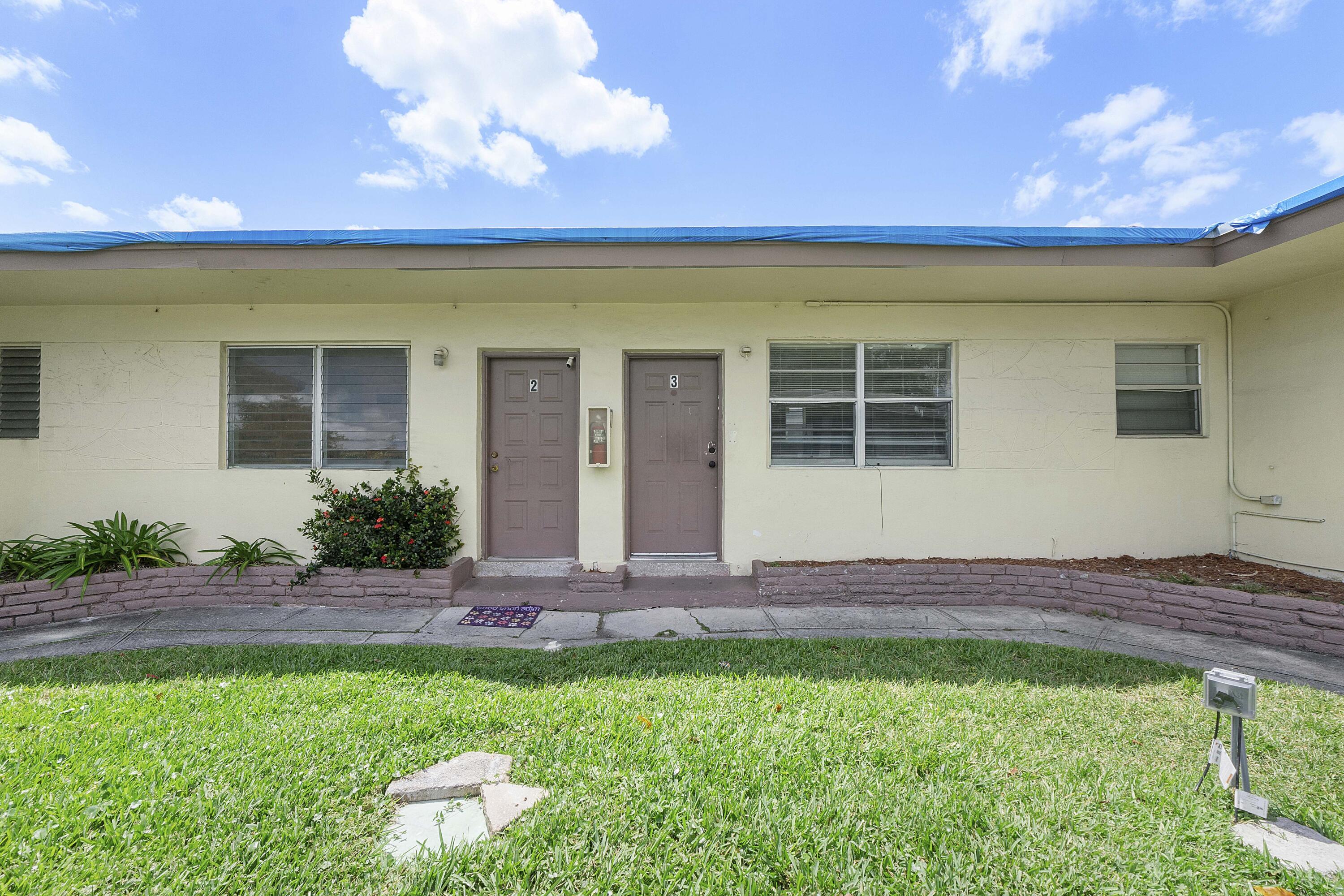 515 Northeast 150th Street, Unit 3 Miami, FL 33161 - Photo 9 of 11 a front view of a house with a yard