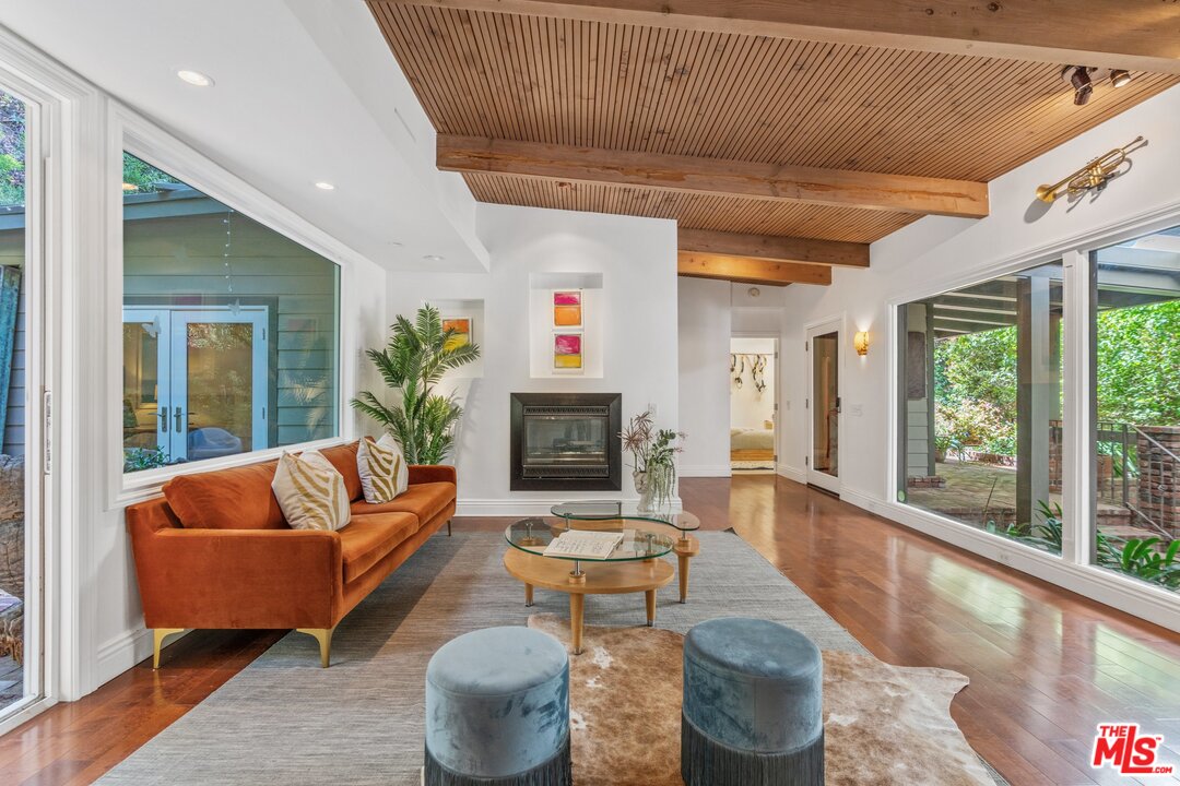 a living room with furniture large window and a fireplace