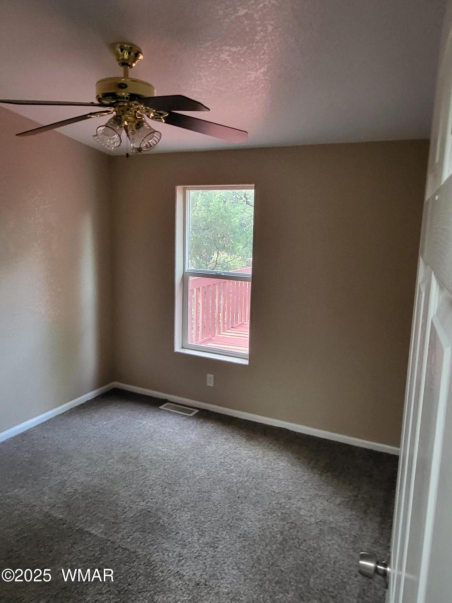 2052 Lone Mountain Road Overgaard, AZ 85933 - Photo 12 of 24 an empty room with a window