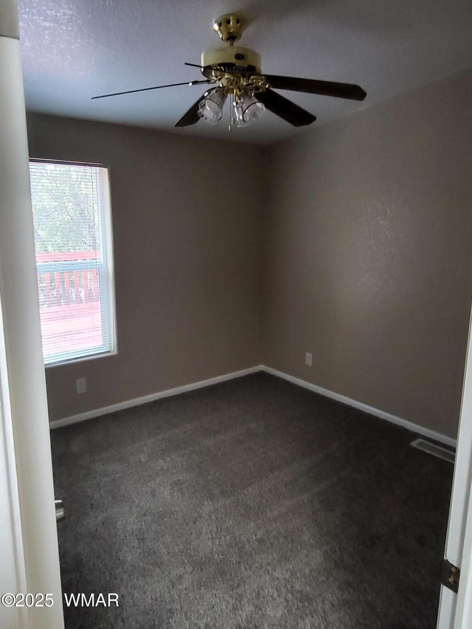 2052 Lone Mountain Road Overgaard, AZ 85933 - Photo 13 of 24 a view of an empty room with a window
