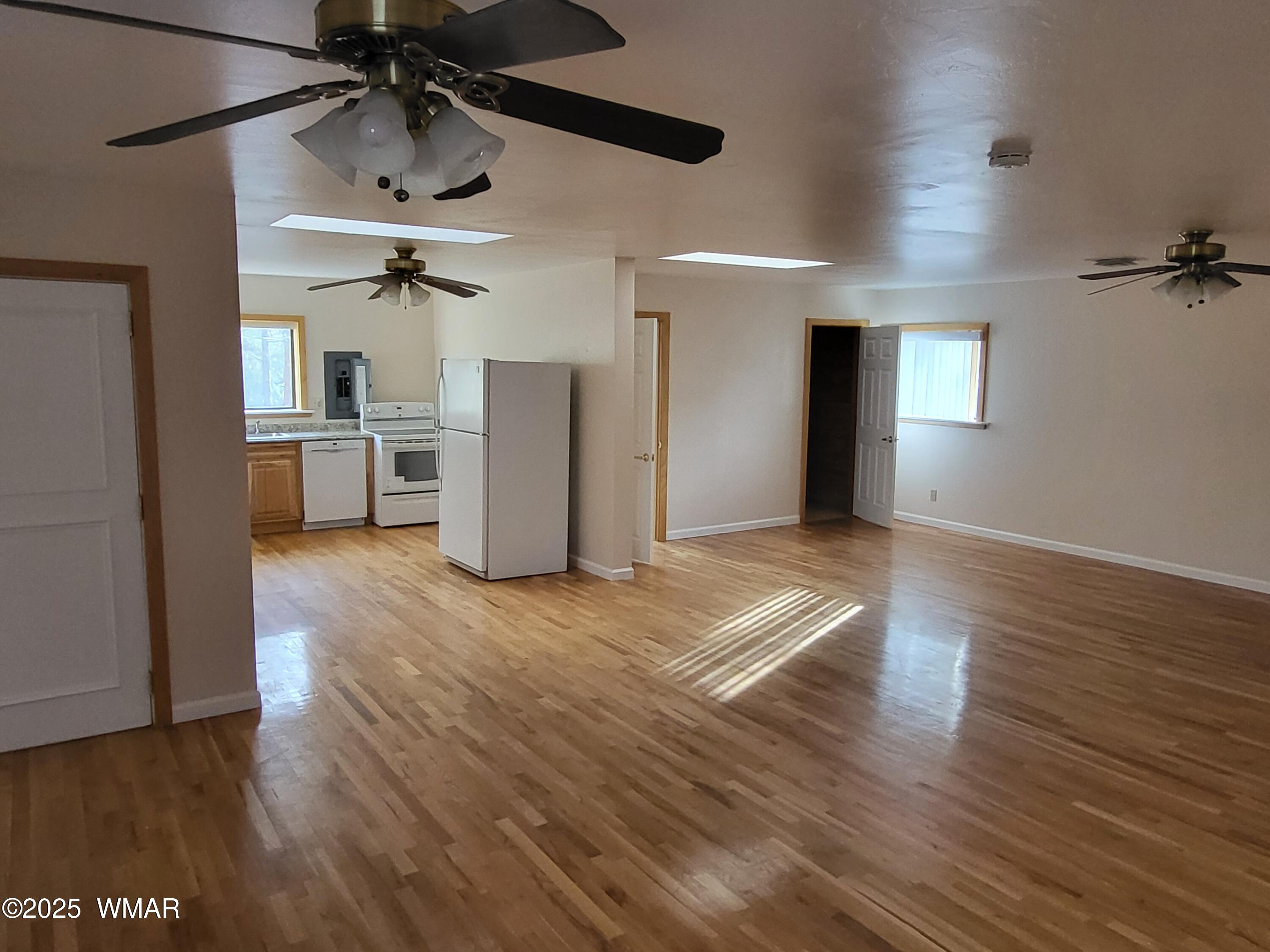 2052 Lone Mountain Road Overgaard, AZ 85933 - Photo 16 of 24 a view of empty room with wooden floor and window