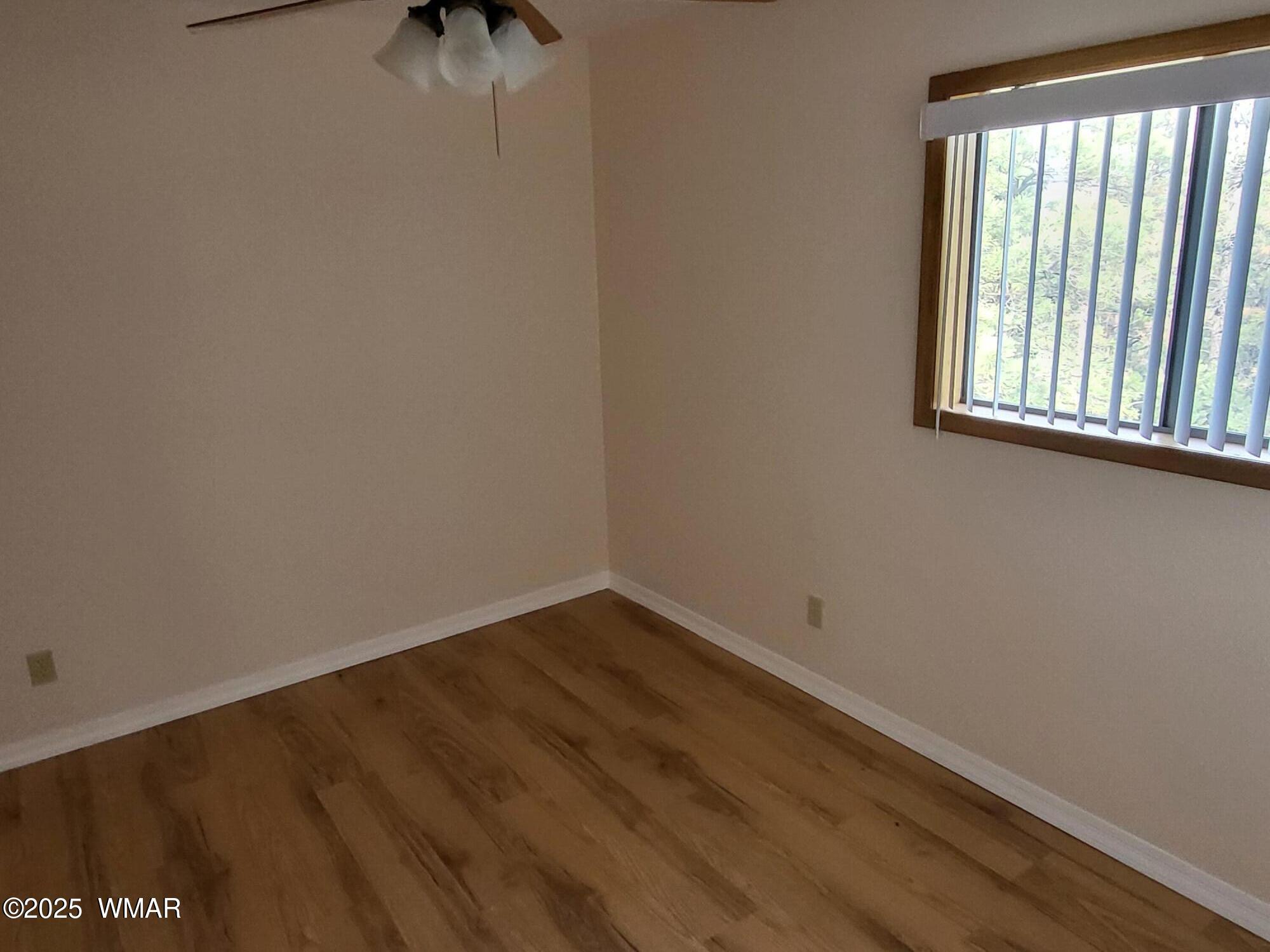 2052 Lone Mountain Road Overgaard, AZ 85933 - Photo 18 of 24 an empty room with a window
