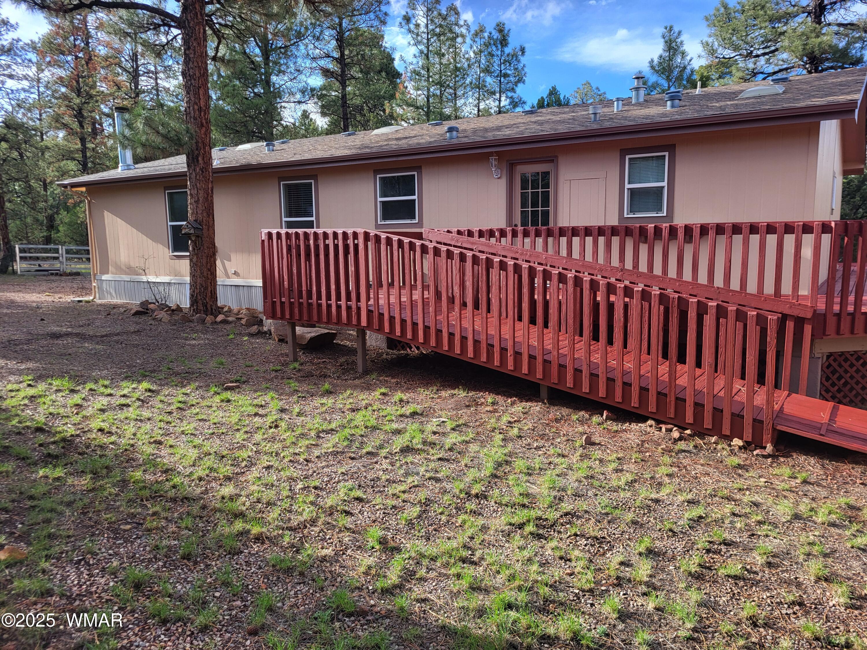 2052 Lone Mountain Road Overgaard, AZ 85933 - Photo 3 of 24 a backyard of a house with a garden
