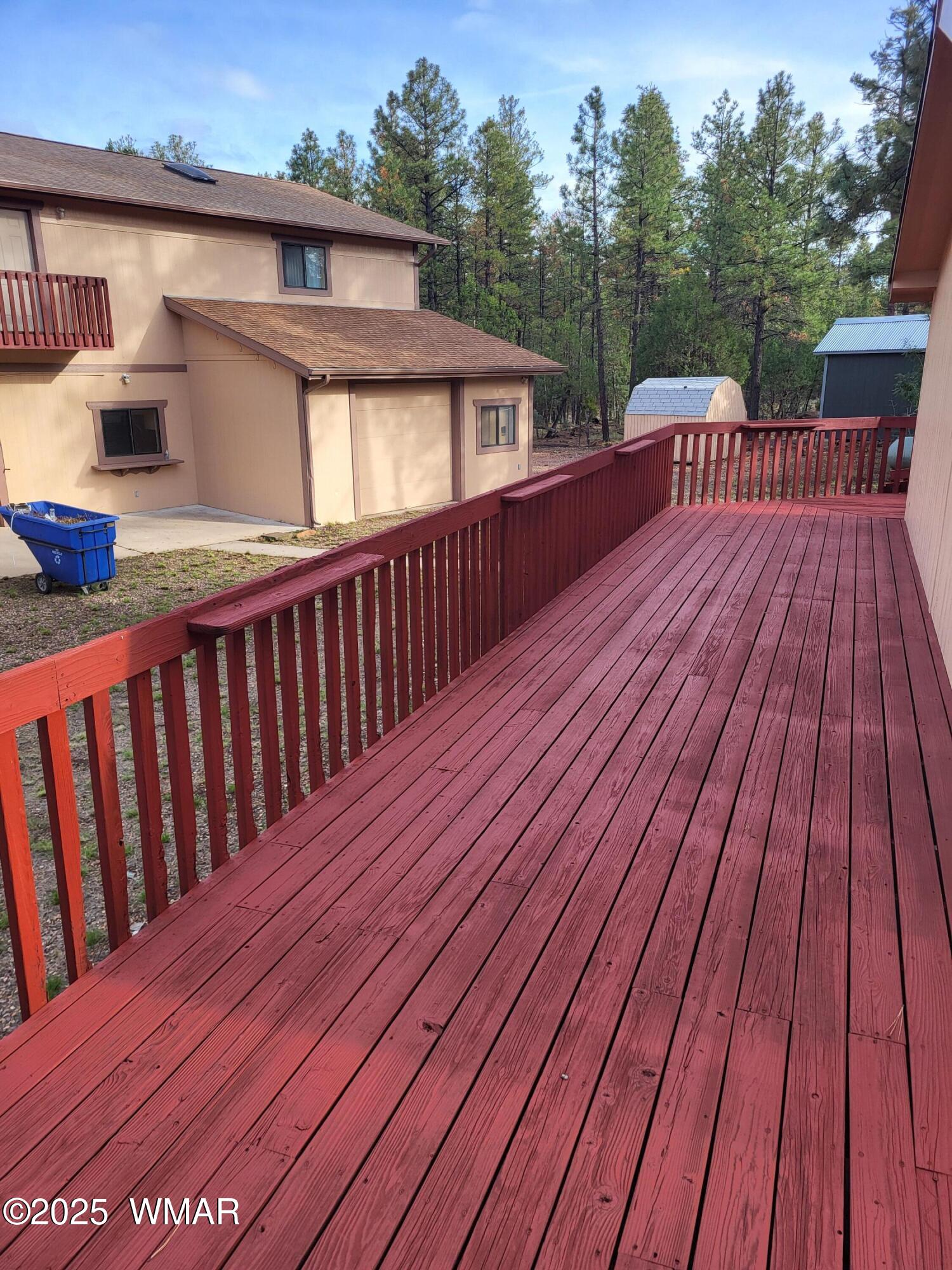 2052 Lone Mountain Road Overgaard, AZ 85933 - Photo 4 of 24 a view of a wooden deck with a yard