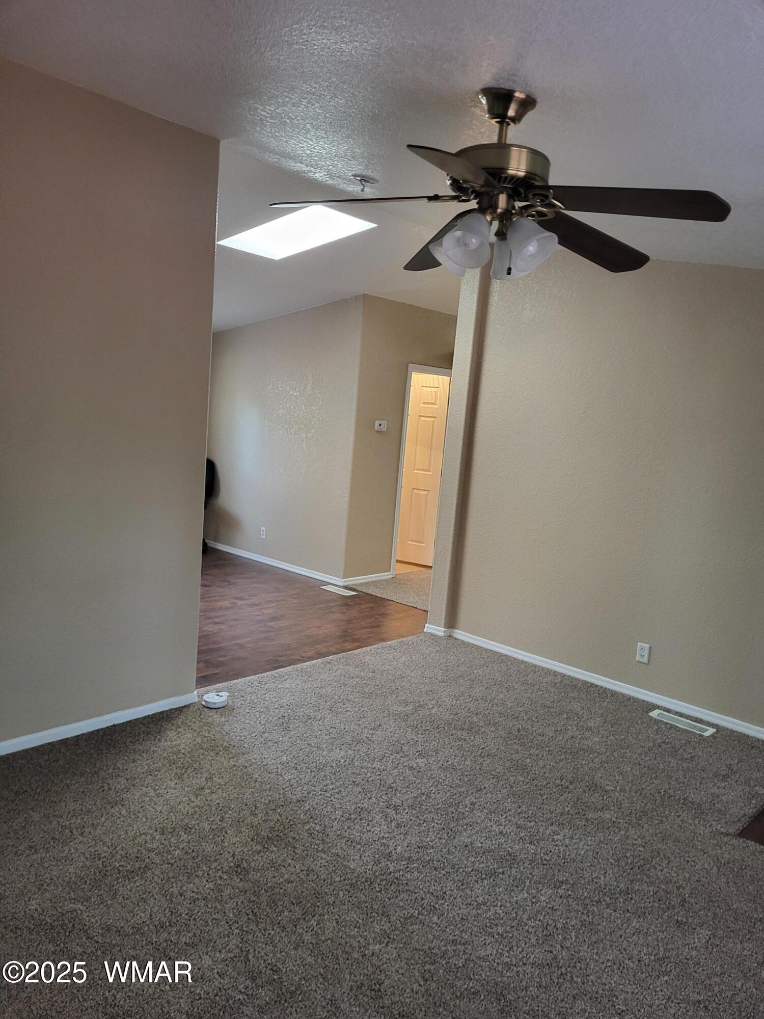 2052 Lone Mountain Road Overgaard, AZ 85933 - Photo 6 of 24 an empty room with a ceiling fan and closet