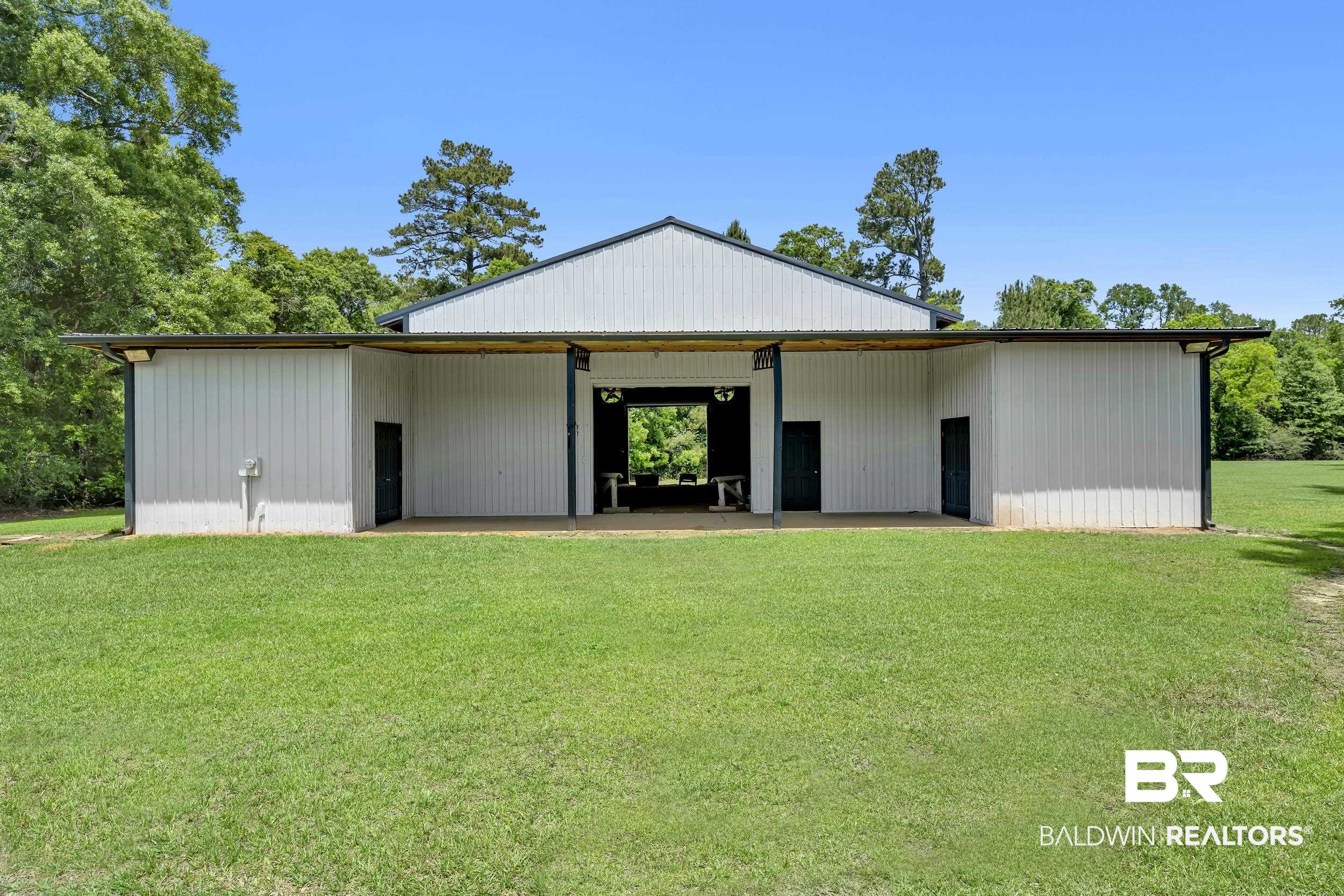 43199 Pine Grove Road Bay Minette, AL 36507 - Photo 17 of 71 Metal building featuring a gable roof, white vertical siding, and a covered patio area