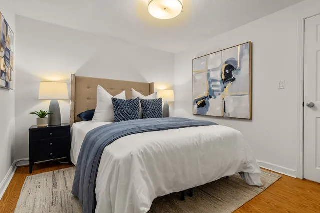 a bedroom with a bed and wooden floor