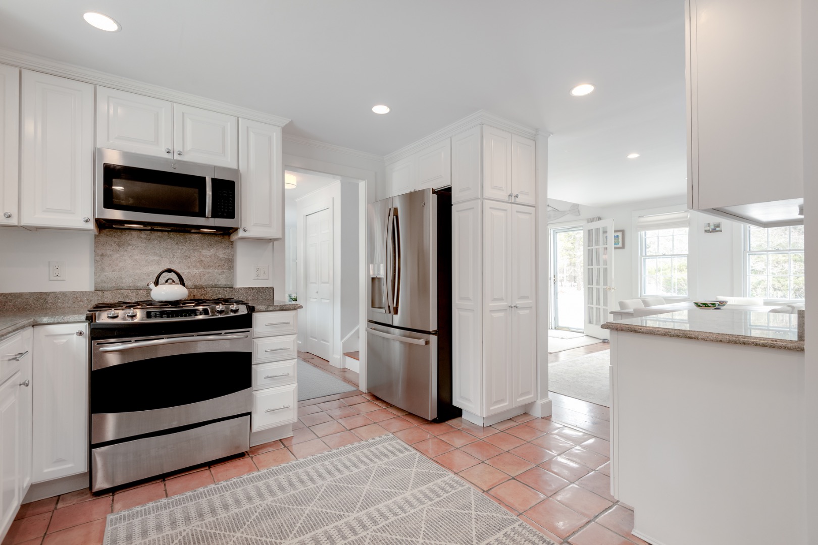 11 Sesapana Road Nantucket, MA 02554 - Photo 14 of 37 a kitchen with stainless steel appliances granite countertop a stove a refrigerator and a microwave
