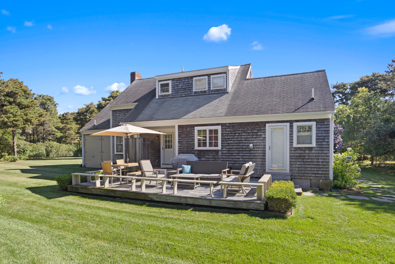 11 Sesapana Road Nantucket, MA 02554 - Photo 32 of 37 a front view of a house with a garden and patio
