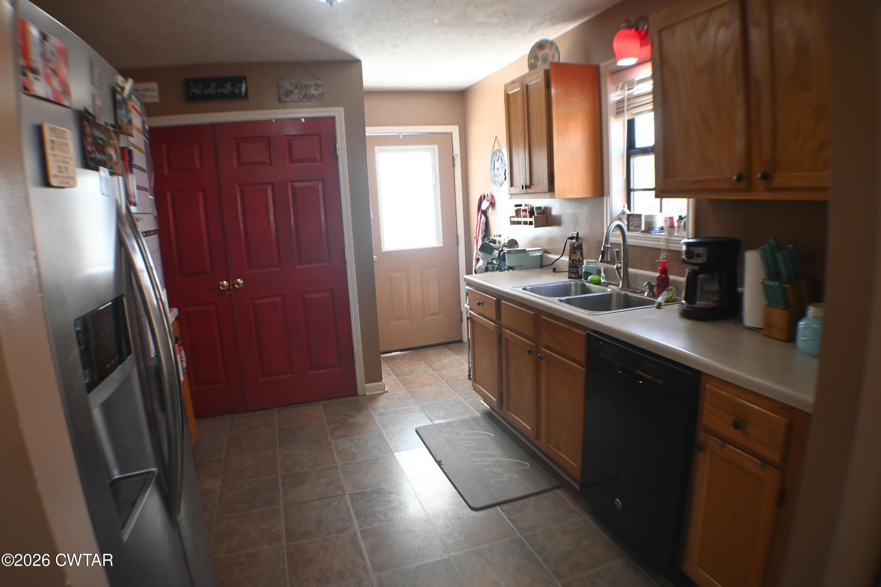 233 South Front Street Halls, TN 38040 - Photo 15 of 23 a kitchen with stainless steel appliances granite countertop a refrigerator and a sink