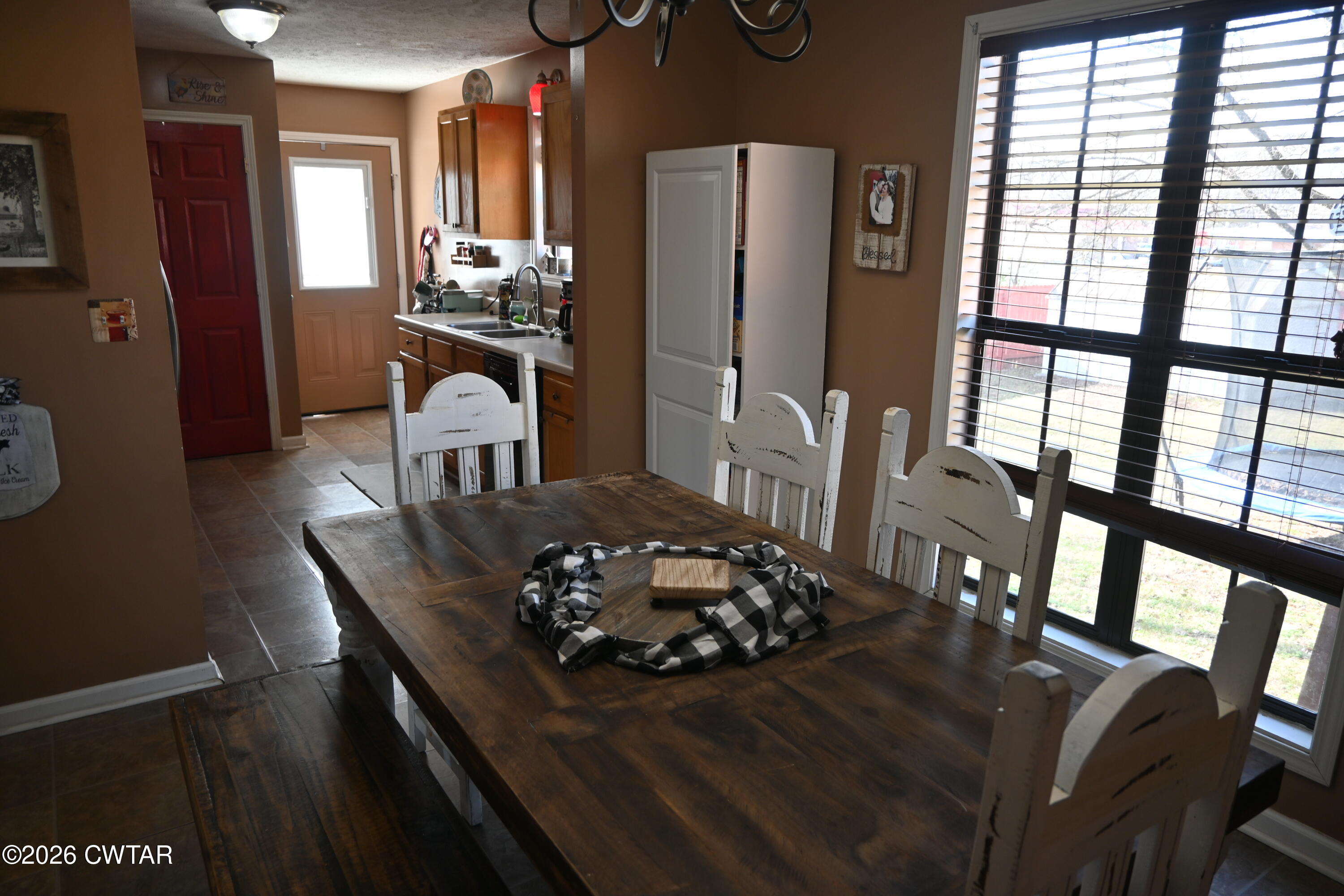 233 South Front Street Halls, TN 38040 - Photo 16 of 23 a kitchen with a table chairs refrigerator and a window