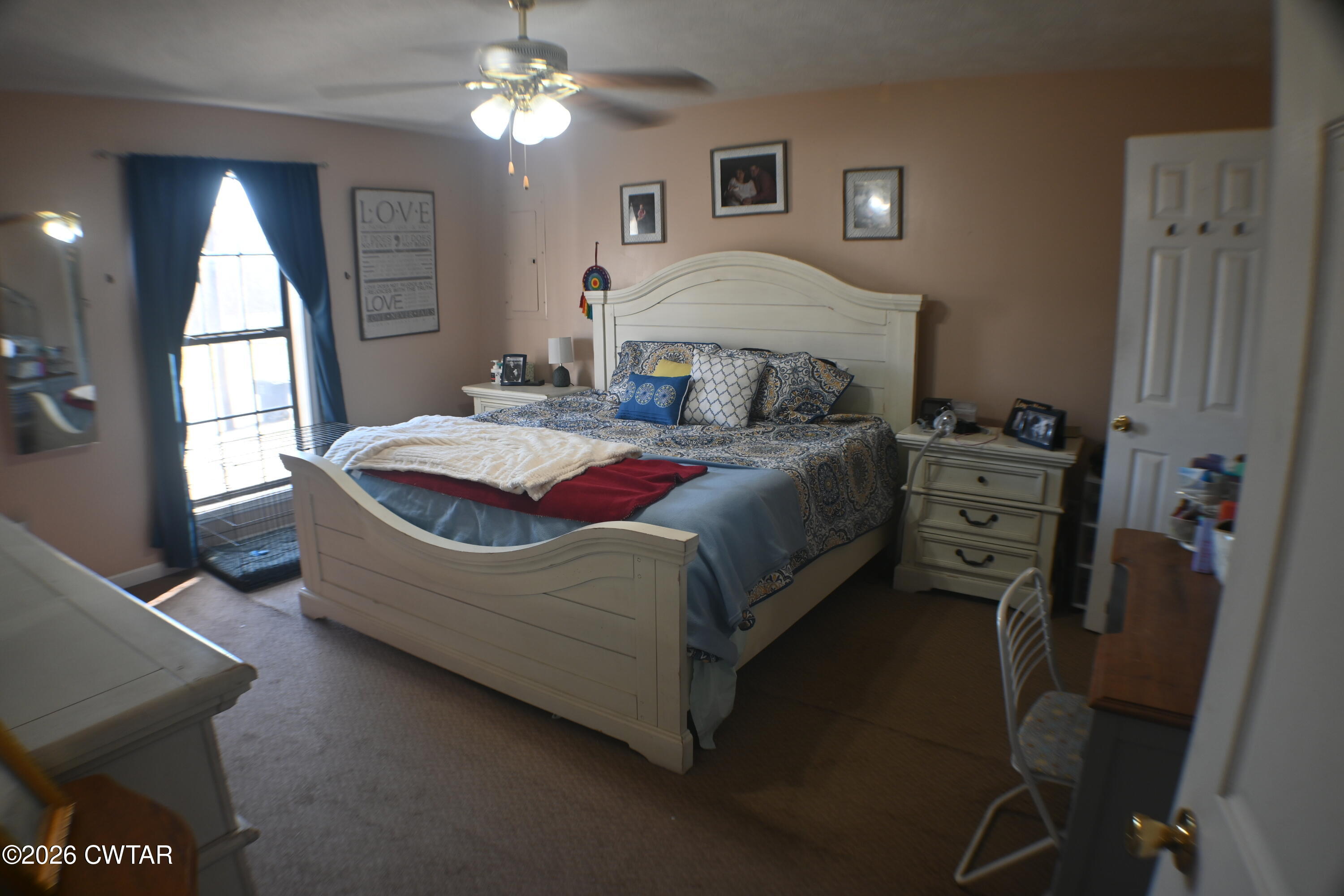 233 South Front Street Halls, TN 38040 - Photo 6 of 23 a bedroom with a bed and a chandelier