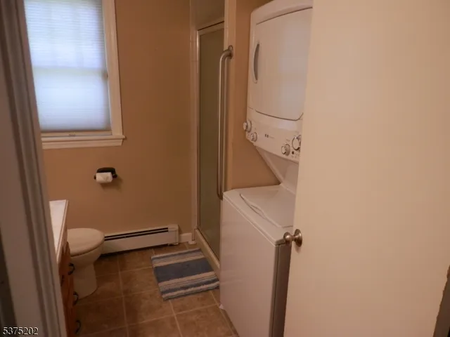 a bathroom with a granite countertop toilet and a shower