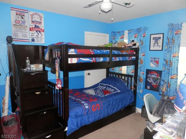 a bedroom with a bed window and wall painting