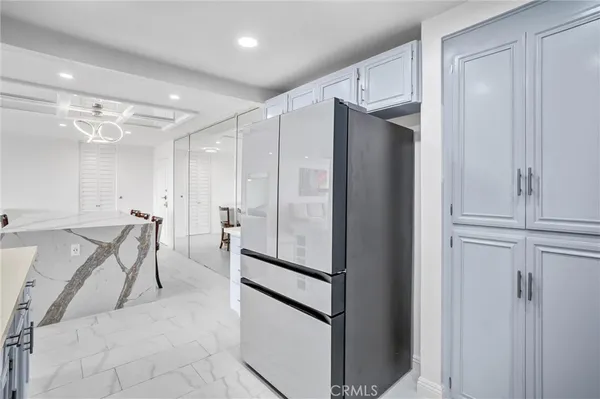 a kitchen with stainless steel appliances granite countertop a refrigerator and a sink