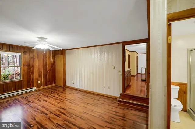 a bathroom with a toilet shower vanity and a sink