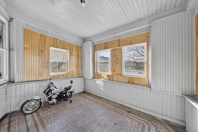 a room with furniture and two window