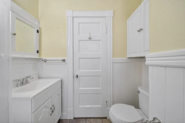 a bathroom with a sink a toilet and vanity